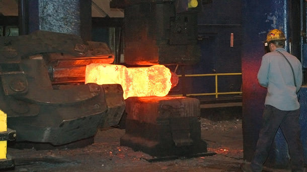 Billet being forged into a spindle shaft forging