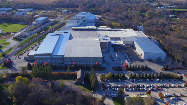Aerial view of a Scot Forge Headquarters, Spring Grove, IL, manufacturing facility, surrounded by trees and parking.